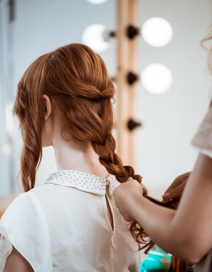 female-hairdresser-making-hairstyle-redhead-woman-beauty-salon_176420-4478